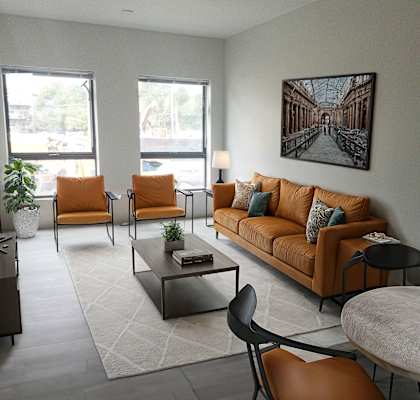 a living room with a couch and chairs and a table