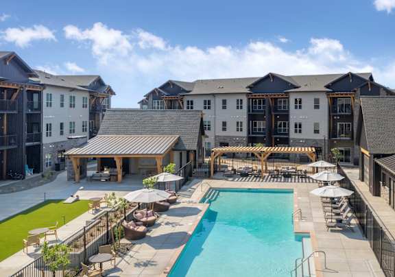 A large building with a pool in front.