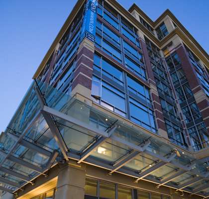 A modern building with a glass facade and a large atrium.at 66 Main, New York