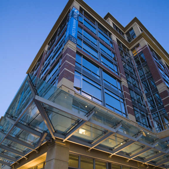 A modern building with a glass facade and a large atrium.