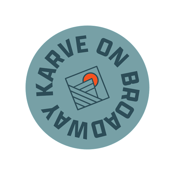 A logo with the text "Karve on Broad" and a graphic of a building with a red sun in the background.