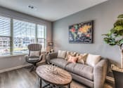 Thumbnail 39 of 53 - a living room with a couch and a chair and a coffee table  at Waterside Residences on Quivira, Kansas, 66215