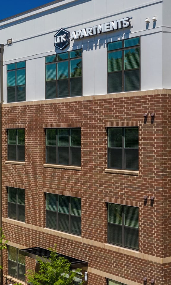 a brick and white building with a sign on top of it  at Link Apartments® Canvas, Atlanta