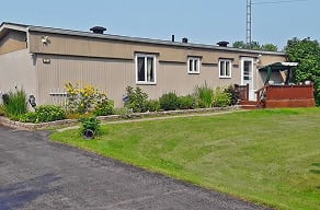A house with a grey roof and a brown fence.