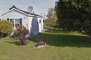 A house with a satellite dish on the roof.