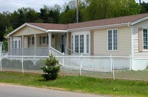 A house with a white fence in front of it.