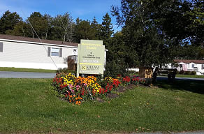 A sign for a community named "Mountain View" is in front of a building.