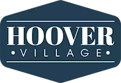A logo with the text "Hoover Village" in white on a dark blue background.