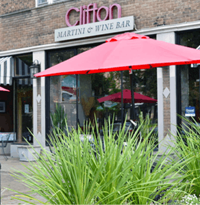 A red umbrella is in front of a Clifton Martini & Wine Bar.
