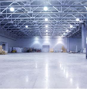 the inside of a large warehouse with boxes on the floor