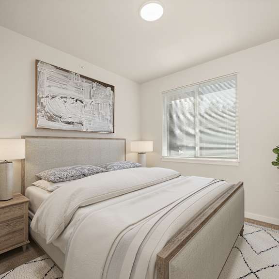A bedroom with a large bed, a nightstand with a lamp, a plant, and a framed picture on the wall.