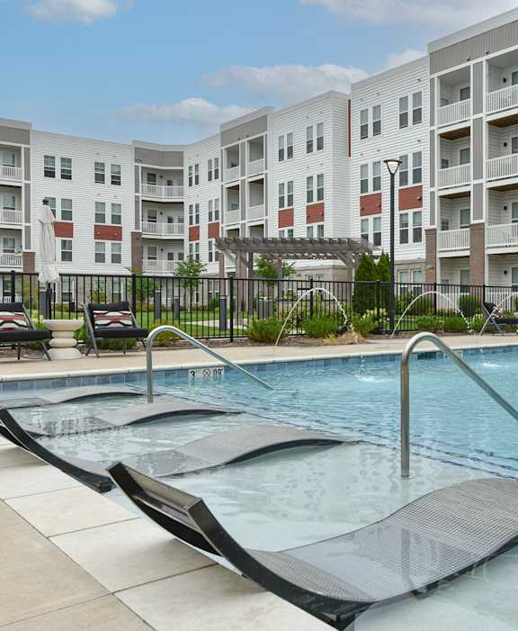 a swimming pool in front of an apartment building