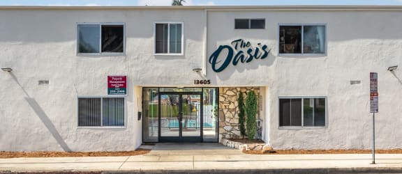 the oasis building on the corner of a street