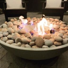 a bowl of rocks with flames in it