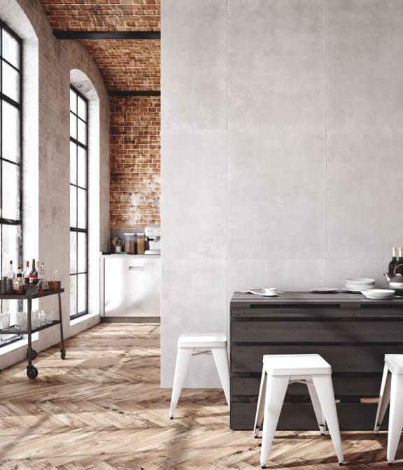 a kitchen with white stools and a table in a loft