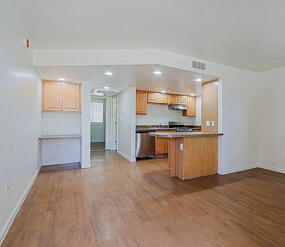 A kitchen with wooden cabinets and a countertop is visible.
