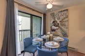 Thumbnail 4 of 15 - Dining Area with View of Private Patio, Blue Chairs, Ceiling Fan/Light
