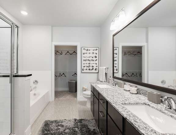a bathroom with a large mirror and two sinks