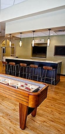 a game room with a pool table and a bar at The Residences at Toscana Park, Granger, Indiana