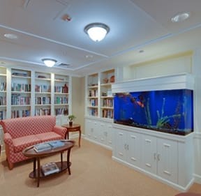 a living room filled with furniture and a large fish tank