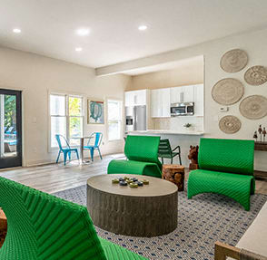 a living room with green chairs and a table