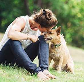 woman and dog in park at Townes at Pine Orchard, Ellicott City, Maryland