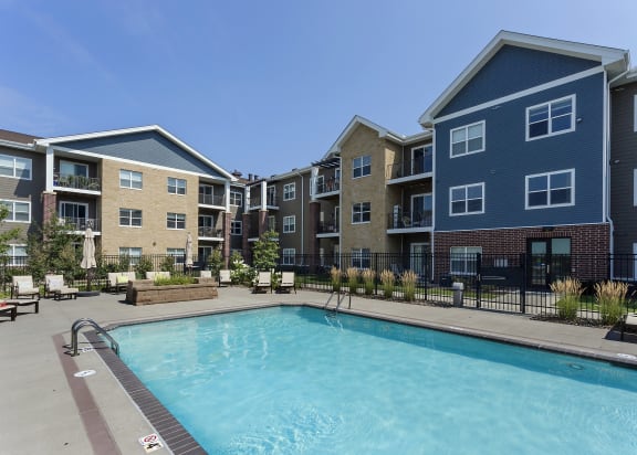 pool with seating located in the middle of the apartment properties
