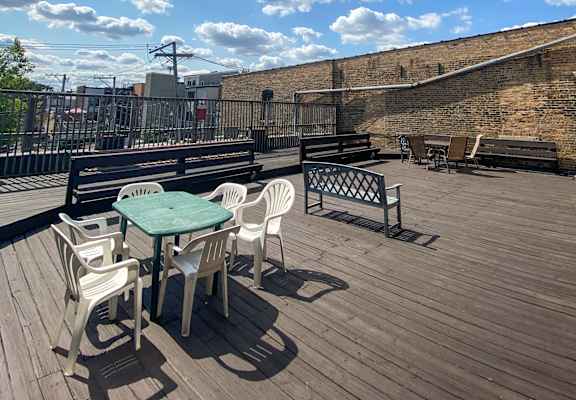 A wooden deck with a table and chairs on it.