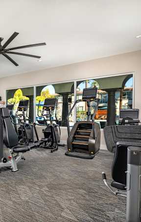 A spacious gym with a variety of equipment including treadmills, weights, and exercise machines.