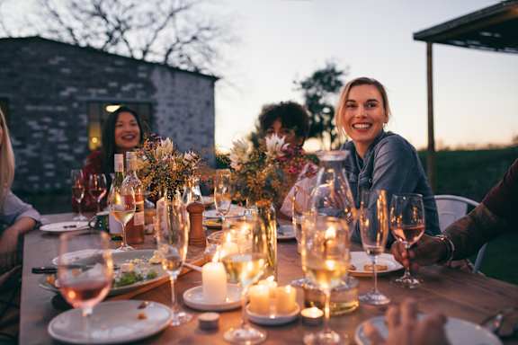 A Group of People Enjoying a Meal and Drinks at The Rey Downtown Apartments, Arizona