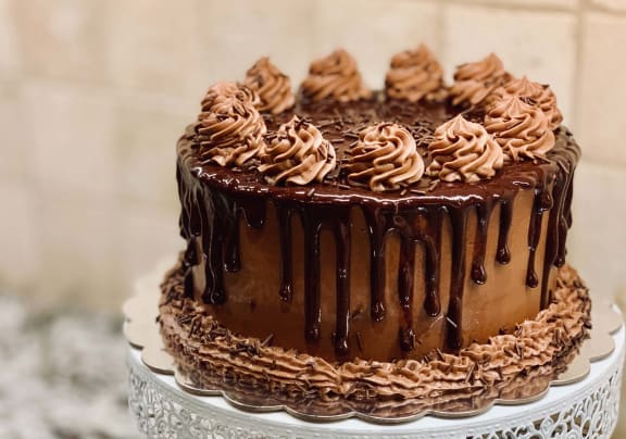 a chocolate cake with chocolate frosting and chocolate sprinkles