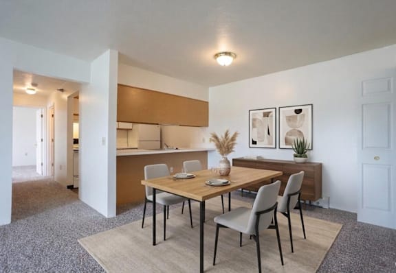 A dining room with a wooden table and chairs.