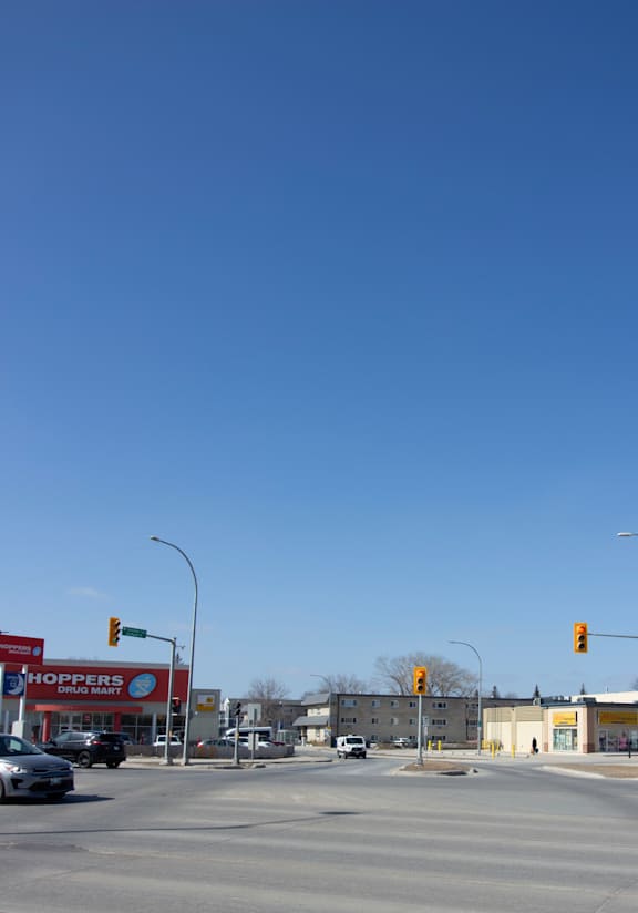A street view with a Shoppers Drug Mart store in the background.
