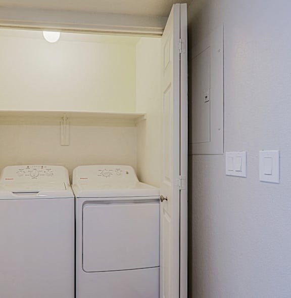 a washer and dryer in a laundry room with white walls