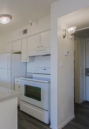 A kitchen with a sink and oven.