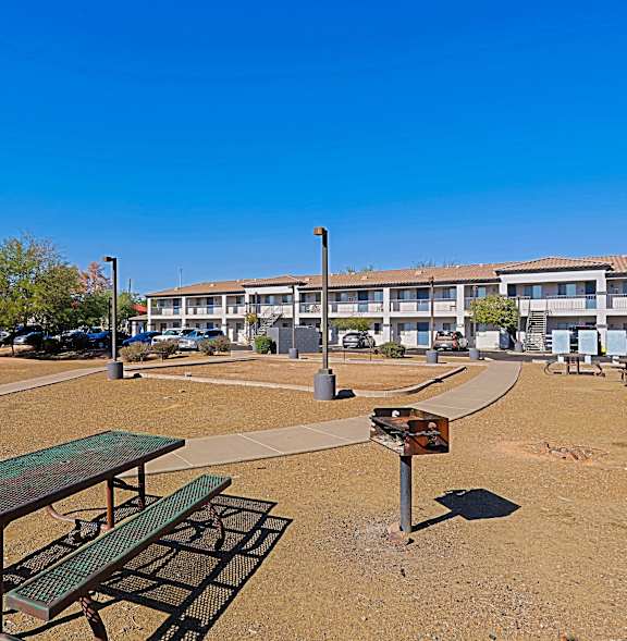 a park with a picnic table in front of a building