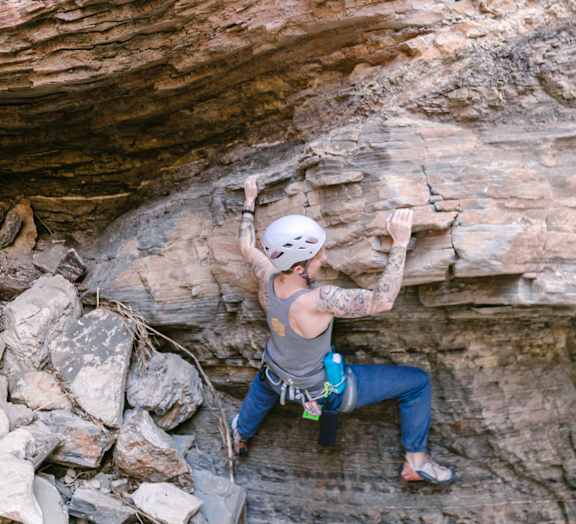 Woman Wearing Helmet Rock Climbing