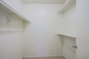 an empty bathroom with white walls and a closet