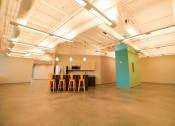 Thumbnail 4 of 8 - a large room with chairs and a kitchen in it