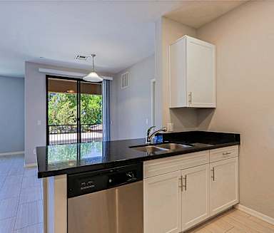 an empty kitchen with a sink and a window