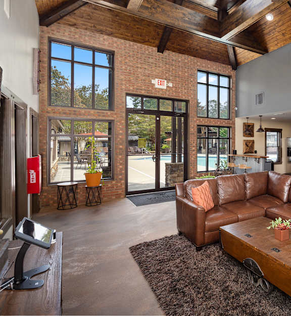 a living room with a leather couch and a coffee table
