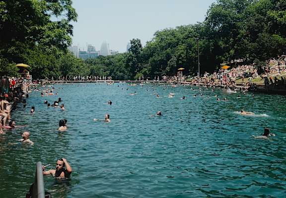 A group of people are swimming in a lake.