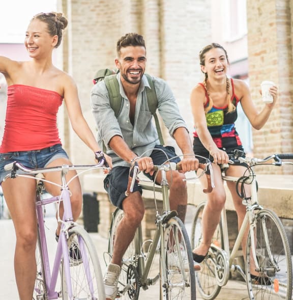 a group of people riding bikes on a street
