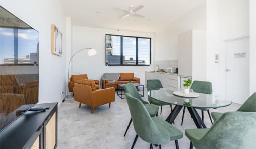 a living room with a glass table and chairs