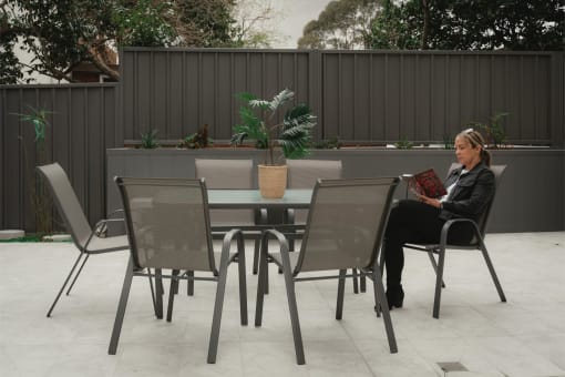 a woman sitting at a table with a book