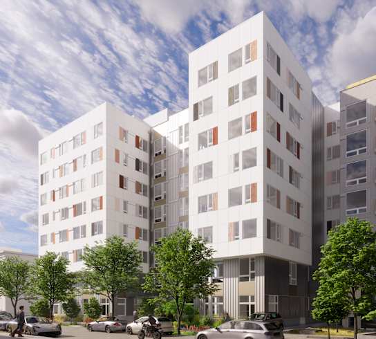 A modern apartment building with cars parked in front.