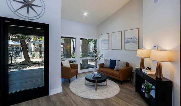 A living room with a couch, a coffee table, and a lamp.