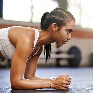 a woman laying on the floor in a gym