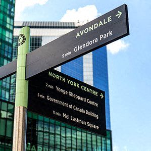 a street sign in front of a tall building