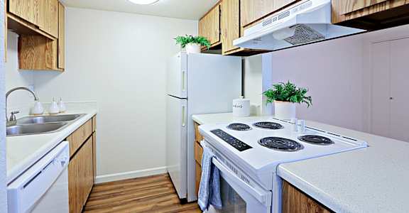 a kitchen with white appliances and wooden cabinets